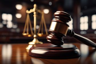 A gavel and scales of justice on a wooden table, symbolizing legal proceedings and court rulings.
