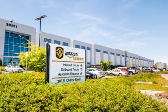 Amazon fulfillment center with signage indicating truck and associate entrances.
